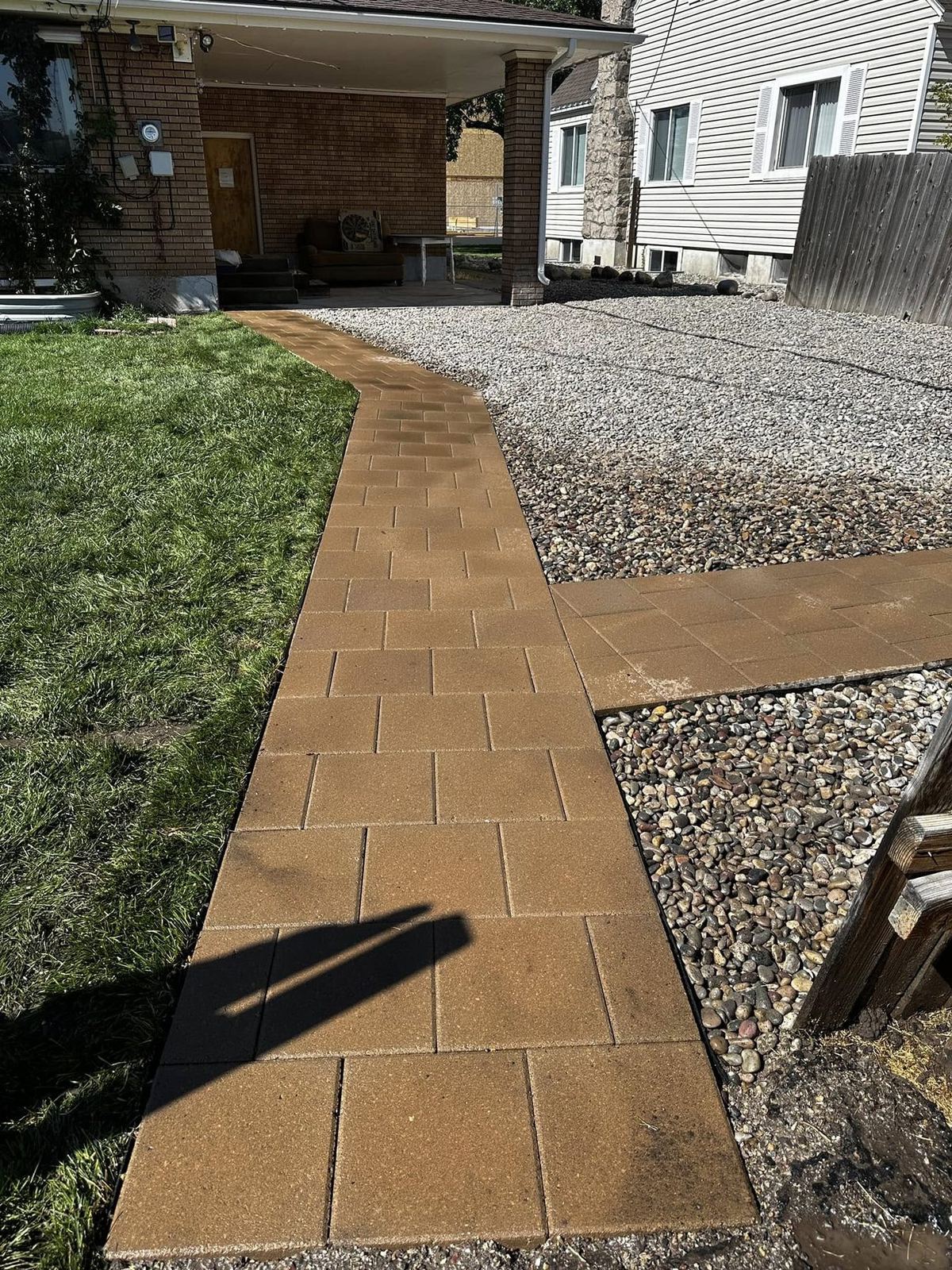 Brick-toned paver walkway leading to a covered porch