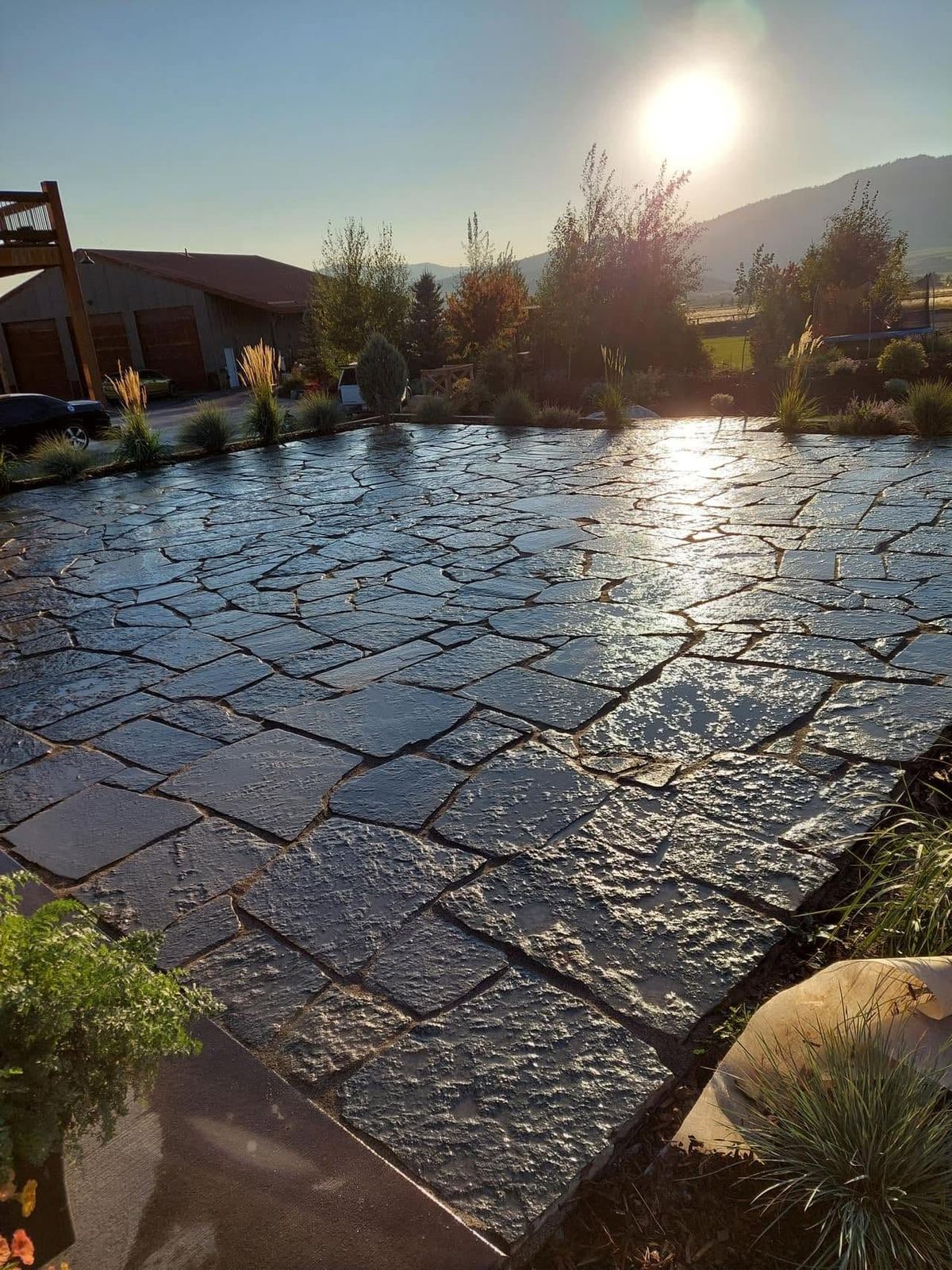 Large flagstone-style paver patio at sunset with mountain views in eastern Idaho