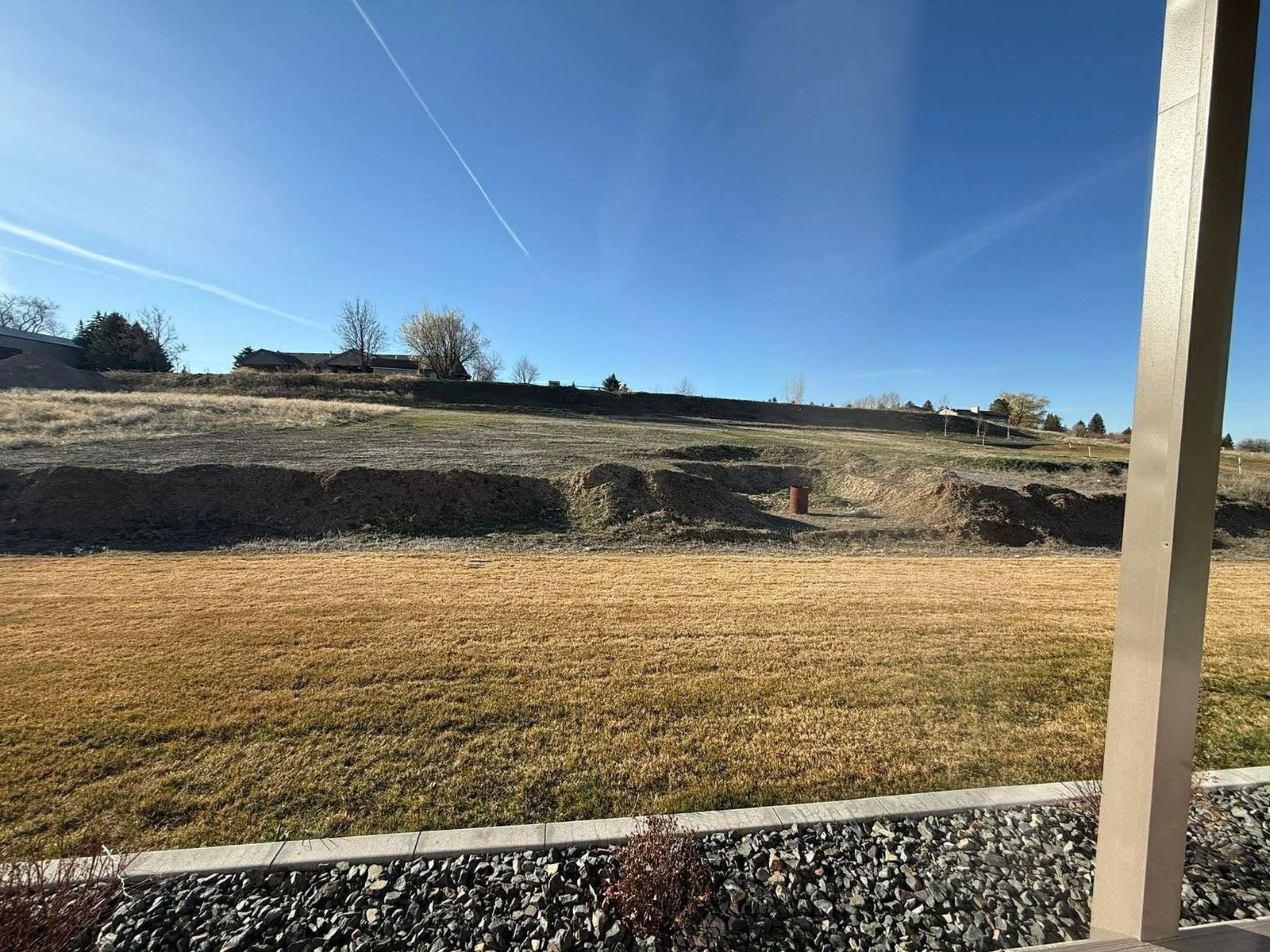 Sloped Idaho Falls back yard before the block retaining wall was built
